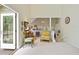 Bright living room with large open patio doors and comfortable yellow chair at 40 Greensward Rd, Kiawah Island, SC 29455