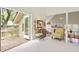 Bright living room with large open patio doors that offer an outdoors view and comfortable chair at 40 Greensward Rd, Kiawah Island, SC 29455