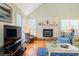 Living room boasts a fireplace, hardwood floors, comfortable seating, and natural light at 40 Greensward Rd, Kiawah Island, SC 29455