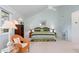 Bright main bedroom featuring vaulted ceilings and a large window showcasing lush greenery at 40 Greensward Rd, Kiawah Island, SC 29455