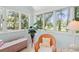 Cozy sitting area with wicker chairs, soft carpet, and an expansive window showcasing lush greenery at 40 Greensward Rd, Kiawah Island, SC 29455