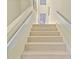 Clean stairway with white risers and carpeted steps leading to the upper level at 40 Greensward Rd, Kiawah Island, SC 29455