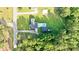 Aerial shot of a home with a pool and a large yard, surrounded by lush greenery and a quiet neighborhood at 400 Black Oak Rd, Bonneau, SC 29431