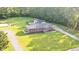 Aerial view of home showcasing lush yard, in-ground pool, detached garage, and long driveway at 400 Black Oak Rd, Bonneau, SC 29431