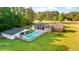 Aerial view of home with backyard pool, screened porch, and lush green surroundings at 400 Black Oak Rd, Bonneau, SC 29431