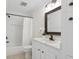 Clean bathroom featuring a shower and tub combo with a white vanity and a modern mirror at 400 Black Oak Rd, Bonneau, SC 29431