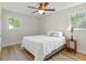 Relaxing bedroom featuring bright windows, stylish wood floors, and a ceiling fan, creating a cozy retreat at 400 Black Oak Rd, Bonneau, SC 29431