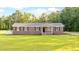 Charming brick home features a manicured lawn and classic shutters at 400 Black Oak Rd, Bonneau, SC 29431
