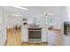 Open kitchen with stainless appliances and an island next to the living room at 400 Black Oak Rd, Bonneau, SC 29431