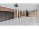 Spacious sunroom featuring brick accent wall, white floors, and ceiling fans for a bright, airy feel at 400 Black Oak Rd, Bonneau, SC 29431