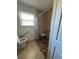 Accessible bathroom featuring a walk-in shower with grab bars and shower seat, a toilet with grab bar, and a window at 415 Parkdale Dr # 6D, Charleston, SC 29414