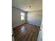 This empty bedroom features hard wood floors, a window that lets in natural light, and a neutral paint color at 415 Parkdale Dr # 6D, Charleston, SC 29414