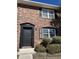 Charming brick townhouse exterior features a black door with black trim and shutters at 415 Parkdale Dr # 6D, Charleston, SC 29414