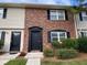 Traditional two-story home featuring a brick facade and light siding, complemented by dark shutters and an entrance door at 415 Parkdale Dr # 6D, Charleston, SC 29414