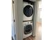 A modern stacked washer and dryer unit in a compact closet space, optimizing laundry convenience at 415 Parkdale Dr # 6D, Charleston, SC 29414