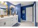 Blue bathroom with double vanity, bright light, and white tiling at 423 Sanctuary Park Dr, Summerville, SC 29486