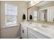 Bright bathroom with double vanity, white cabinets, and large mirror at 423 Sanctuary Park Dr, Summerville, SC 29486