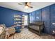 Bedroom with blue walls, hockey themed decor and a comfortable chair at 423 Sanctuary Park Dr, Summerville, SC 29486
