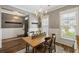 Bright dining area featuring a wooden table, chandelier, and view to the exterior at 423 Sanctuary Park Dr, Summerville, SC 29486