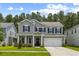 Charming two-story home with gray siding, black shutters, and a well-manicured front lawn at 423 Sanctuary Park Dr, Summerville, SC 29486
