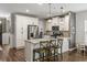 Well-equipped kitchen with a large island, pendant lighting, and stainless steel refrigerator at 423 Sanctuary Park Dr, Summerville, SC 29486