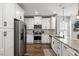 Modern kitchen with white cabinets, stainless steel appliances, and granite countertops at 423 Sanctuary Park Dr, Summerville, SC 29486