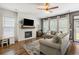 Comfortable living room with fireplace, shiplap accent wall, and plush seating at 423 Sanctuary Park Dr, Summerville, SC 29486