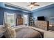 Primary bedroom featuring blue walls, natural light, and wood furniture at 423 Sanctuary Park Dr, Summerville, SC 29486