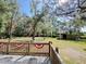 Beautiful view from the deck with trees, creek, wooden shelter and patriotic banner at 4589 Prices Bridge Ln, Walterboro, SC 29488