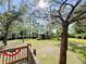 Beautiful backyard view from wood deck with trees, creek, wooden shelter and patriotic banner at 4589 Prices Bridge Ln, Walterboro, SC 29488
