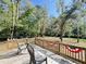View of spacious backyard from wooden deck with two chairs and decorative patriotic banner at 4589 Prices Bridge Ln, Walterboro, SC 29488