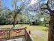 Great home boasts a large backyard with trees, creek, wooden shelter and patriotic banner at 4589 Prices Bridge Ln, Walterboro, SC 29488