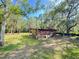 Large backyard with a weathered shed and shade trees, offering a peaceful, natural setting at 4589 Prices Bridge Ln, Walterboro, SC 29488
