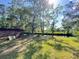 Expansive backyard with lush greenery and a serene waterfront view under a bright, sunny sky at 4589 Prices Bridge Ln, Walterboro, SC 29488