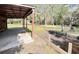 Outbuilding with concrete patio next to a wooden-lined drainage ditch in a lush, green backyard at 4589 Prices Bridge Ln, Walterboro, SC 29488