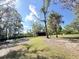 Lush green backyard with mature trees and a shelter, offering a peaceful and shaded outdoor space at 4589 Prices Bridge Ln, Walterboro, SC 29488