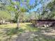 Expansive backyard with a storage shed surrounded by mature trees, ideal for outdoor storage and activities at 4589 Prices Bridge Ln, Walterboro, SC 29488