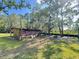 Spacious yard featuring a rustic wooden shed and ample green space, perfect for outdoor activities at 4589 Prices Bridge Ln, Walterboro, SC 29488