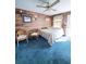 Inviting bedroom with ceiling fan, wood-look walls, and light blue carpet at 4589 Prices Bridge Ln, Walterboro, SC 29488