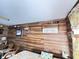 Cozy bedroom features wood-look walls, a ceiling fan, and floral accents at 4589 Prices Bridge Ln, Walterboro, SC 29488