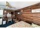 Cozy bedroom with wood-look walls, ceiling fan, TV, and floral bedding at 4589 Prices Bridge Ln, Walterboro, SC 29488