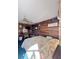 Cozy bedroom with wood paneling and floral comforter at 4589 Prices Bridge Ln, Walterboro, SC 29488