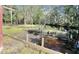 Backyard with a wooden drainage feature separating the yard from the creek, surrounded by mature trees at 4589 Prices Bridge Ln, Walterboro, SC 29488