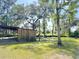 Charming wooden shed surrounded by lush greenery and a clear blue sky at 4589 Prices Bridge Ln, Walterboro, SC 29488