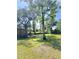 Cozy exterior view with a wooden shed, surrounded by lush trees and a clear sky at 4589 Prices Bridge Ln, Walterboro, SC 29488