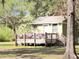 Charming cottage featuring a quaint porch with festive decorations and a cozy ambiance at 4589 Prices Bridge Ln, Walterboro, SC 29488