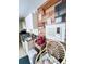 Compact kitchen area with white cabinets, wood-look accent wall, and vintage decor at 4589 Prices Bridge Ln, Walterboro, SC 29488