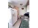 Efficient kitchen layout with white refrigerator, ample storage, and modern sink at 4589 Prices Bridge Ln, Walterboro, SC 29488