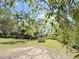 Lush land features vibrant trees, a charming shed, and a quaint storage unit at 4589 Prices Bridge Ln, Walterboro, SC 29488