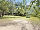Expansive land featuring lush trees, an open structure, and a green storage unit at 4589 Prices Bridge Ln, Walterboro, SC 29488